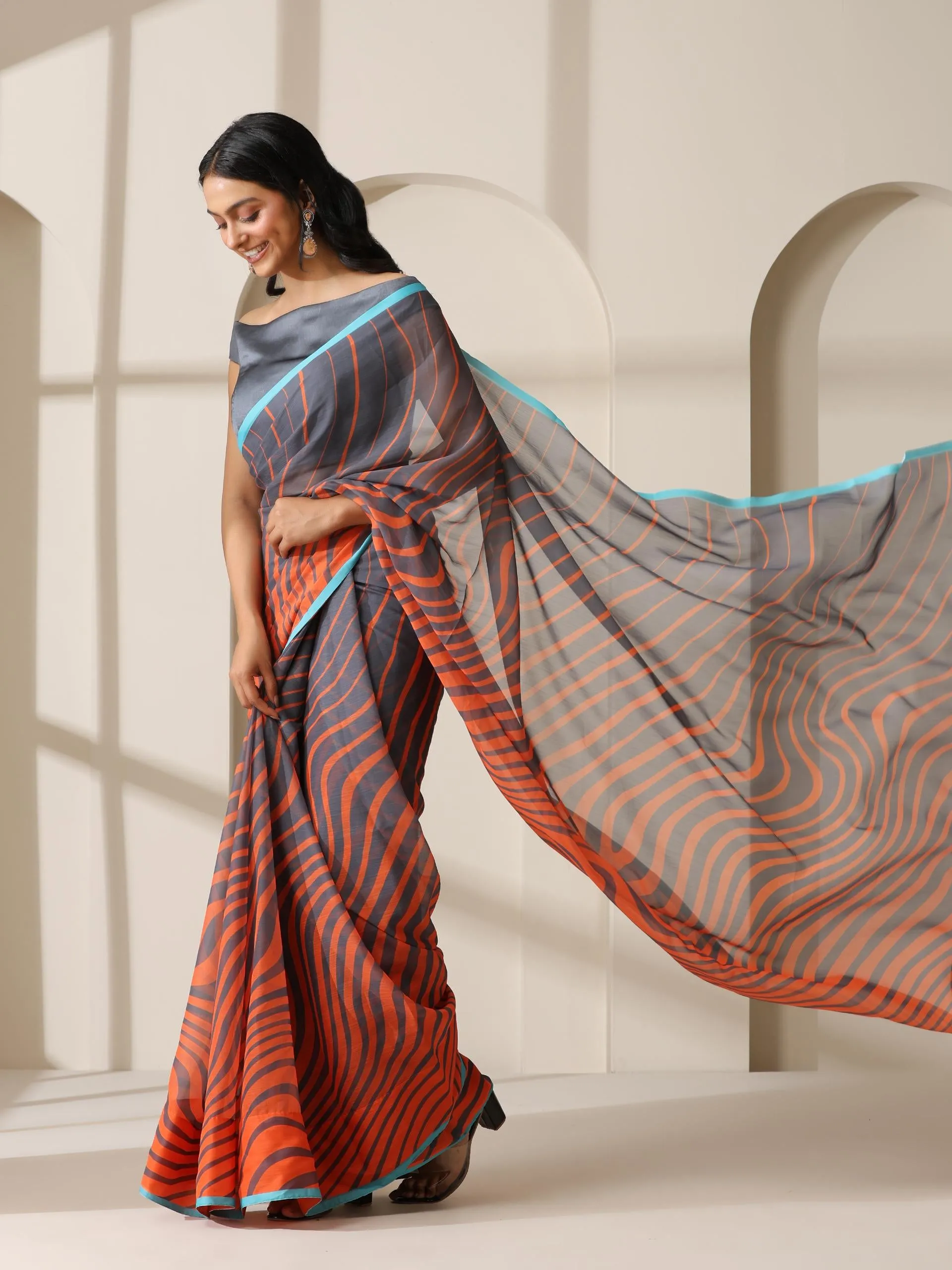 Lava Orange Waves Chiffon Print Saree with Blue Border & Grey Blouse Fabric